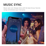 Music Sync can change colors with the beat of your favorite songs and enhance your next party. Image shows friends dancing together under changing light bulb colors of a PAR30 LED Smart Bulb. Image includes a closeup of a smart phone showing the Music Sync setting options on a smart phone. You can use a compatible tablet, too. Just keep the smart device, the smart bulb, and your music in the same room and your lights can dance to the beat with you.